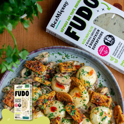 Plated dish of roasted Fudo and vegetables with Fudo packaging in the background