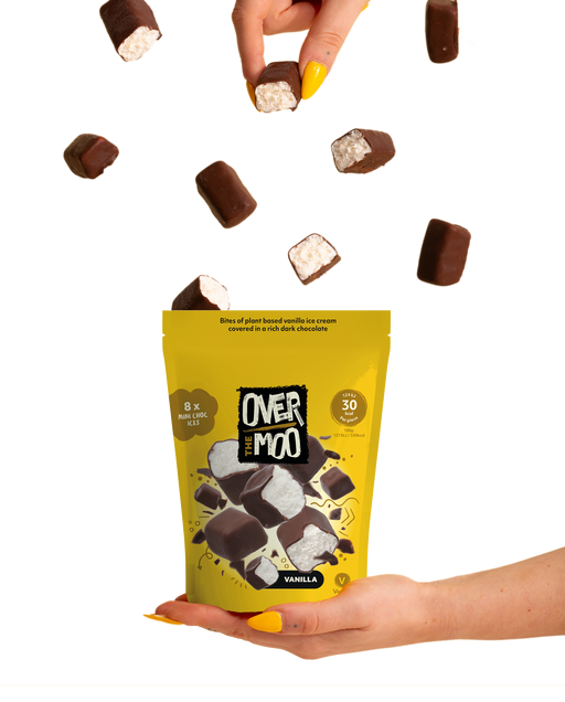 hand holding vanilla over the moo pouch with chocolate covered ice cream bites falling from the sky
