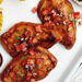 arley's vegan chicken breast topped with tomato salsa on a white plate