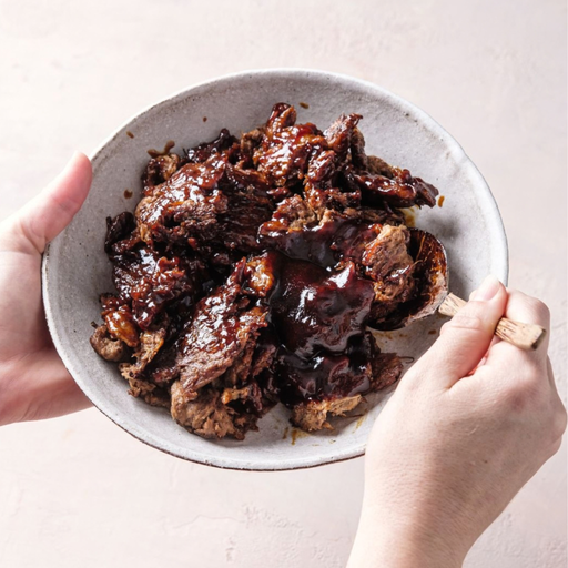 bowl of vegan mushroom meaty brisket in bbq sauce