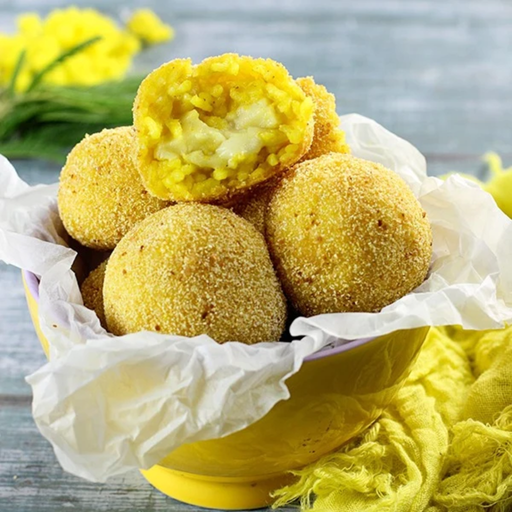 aranchini rice balls with vegan smoked mozzarella in the middle in a yellow bowl