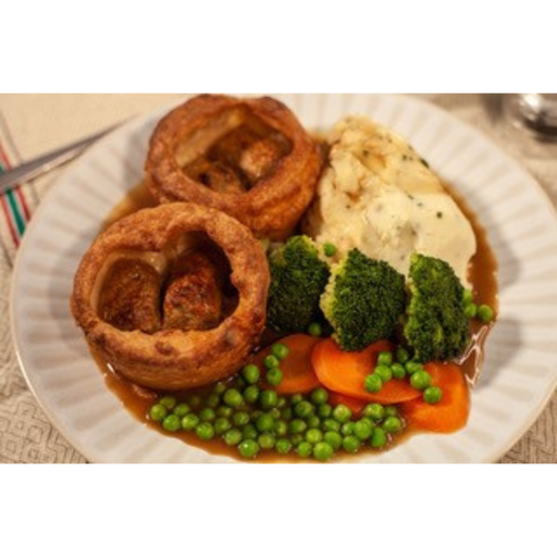 Plated dish with roasted meat, vegetables, and Yorkshire pudding on a white plate.