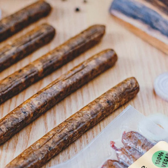 close up of plenty reasons onion and garlic kabanos sausages on a wooden board