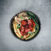juicy marbles filet served on a a bed of salad in a bowl on marbled background