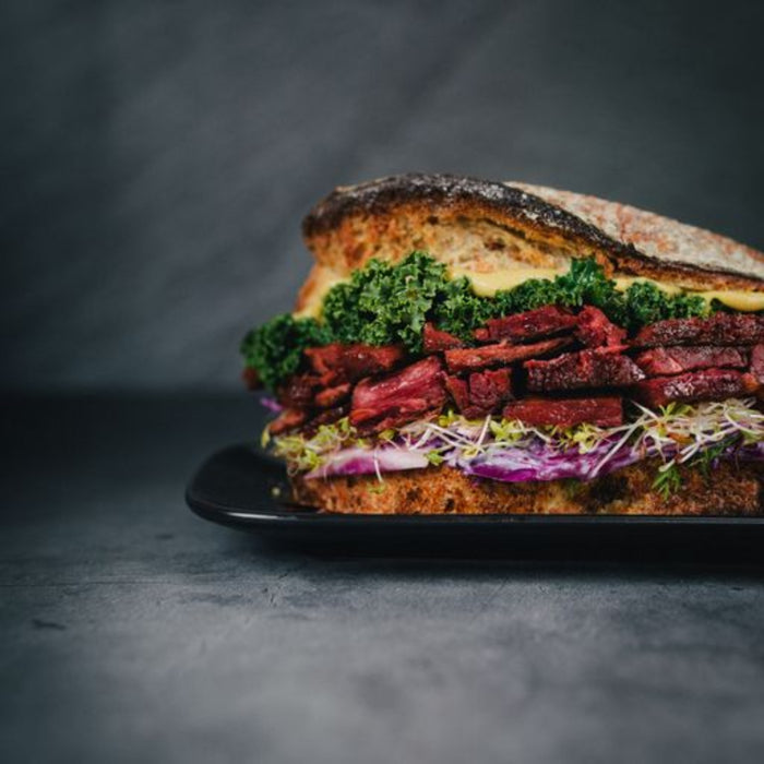 juicymarbles loin served in a sandwich with salad